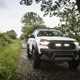 Ford Ranger M-Sport review - white, front view, lights on, driving along country lane