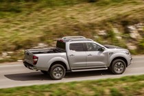 Renault Alaskan pickup review - rear side view, driving through countryside