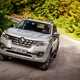 Renault Alaskan pickup review - front view, driving on gravel road in countryside
