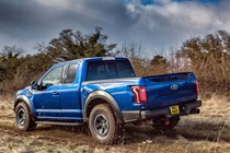 Ford F-150 Raptor review - blue, rear view, driving off road