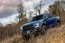 Ford F-150 Raptor review - blue, front view, driving off road downhill