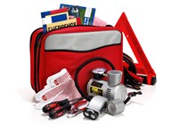 Emergency car kit in red bag with all items spilling out