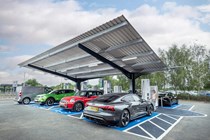Variety of electric vehicles parked on the forecourt of new EV charging Hyperhub in York, complete with solar powered canopy