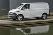 VW Transporter T6.1 facelift - side view, white panel van, driving