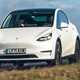 Tesla Model Y, white, driving over crest - Safest cars in the UK 2023