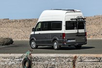 VW Grand California camper review - rear view, beige and white, parked on docks