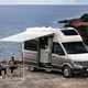 VW Grand California camper review - camping on the rocks near the coast, white and beige