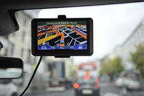 Aftermarket sat-nav device attached to the windscreen of a vehicle driving around Cork, Ireland