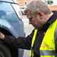 Man checking car tyre - What is personal contract hire