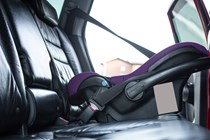 Rear-facing car seat in car back seat