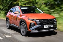 Bestselling cars in the UK 2024: Hyundai Tucson, front three quarter driving, orange paint