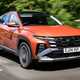 Bestselling cars in the UK 2024: Hyundai Tucson, front three quarter driving, orange paint