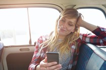 Woman enjoying wi-fi in a car