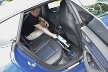 Ryan Gilmore cleans a car with the Hoover HL9, a cordless vacuum cleaner