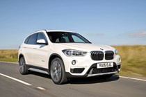 Best family SUVs for less than £15,000: BMW X1, front three quarter driving, white paint