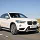 Best family SUVs for less than £15,000: BMW X1, front three quarter driving, white paint