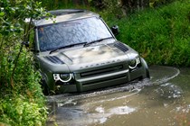 How to drive off-road: Land Rover Defender, front three quarter driving, through water, close up, green paint