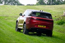 How to drive off-road: Range Rover Sport, driving on grass, rear three-quarter view, red paint