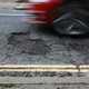 A car about to pass over a pothole.