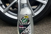 The Turtle Wax wheel cleaner next to an alloy wheel