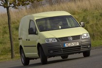 VW Caddy 3 - pale yellow, front view, driving round corner
