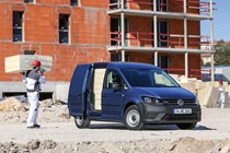 VW Caddy 4 - blue, front view, construction site, being loaded
