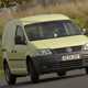 VW Caddy 3 - pale yellow, front view, driving round corner