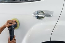 Polishing pad being used on a white car
