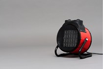 A portable space heater on a grey background