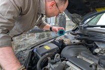 Image of writer Graham King checking the coolant level in a 2001 Volvo V70