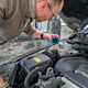 Image of writer Graham King checking the coolant level in a 2001 Volvo V70