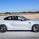White BMW M2 Competition Coupe side elevation driving