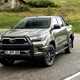 2020 Toyota Hilux facelift - front view, driving round corner, Titan Bronze