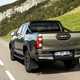2020 Toyota Hilux facelift - rear view, driving on road, Titan Bronze