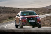 A red DS 3 compact SUV steering around a bend