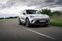 A silver Smart #1 Brabus driving on a cloudy day