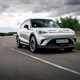 A silver Smart #1 Brabus driving on a cloudy day