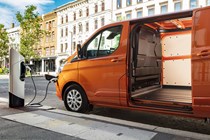 Best hybrid van UK 2021 - Ford Transit Custom PHEV plugged in to charge, orange