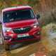 Vauxhall Combo Cargo 4x4 review - red, front view, splashing through mud