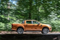 Ford Ranger side view driving in a forest