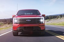 Ford F-150 Lightning electric pickup truck, dead-on front view, red, driving
