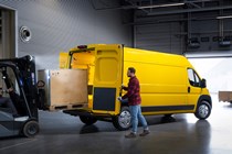 Vauxhall Movano-e electric van, rear view, being loaded, yellow