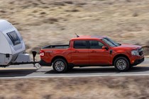 Ford Maverick pickup truck, side view, orange, towing caravan