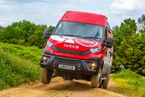 Iveco Daily 4x4 All-Road panel van, front view, red, on three wheels over bump