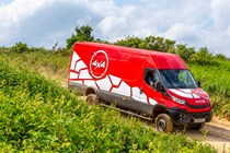 Iveco Daily 4x4 All-Road panel van, red, side view, driving down slope off-road