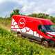 Iveco Daily 4x4 All-Road panel van, red, side view, driving down slope off-road