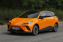 Best electric family cars: MG 4 EV front three quarter driving, orange paint