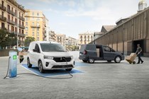 Nissan Townstar small van - white electric van charging, grey petrol van being loaded