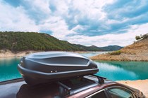 A car roof box overlooking a lake
