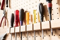 A selection of screwdrivers on a wall